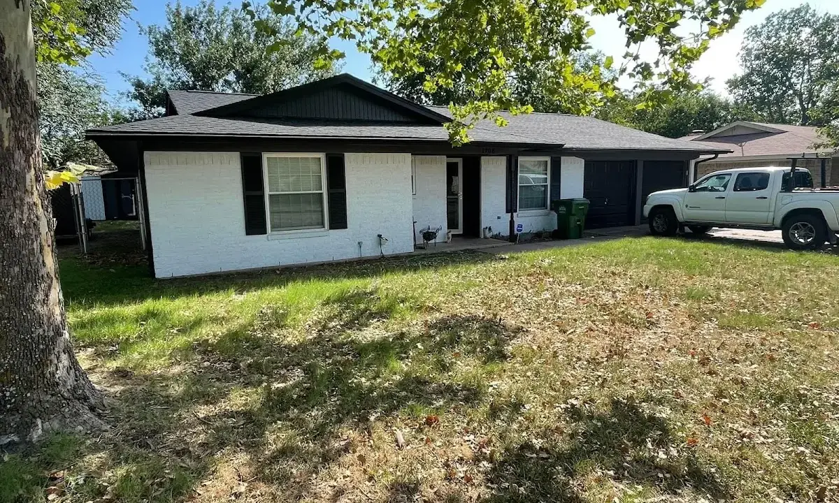 Professional roofing crew working on a residential roof in Atkinson